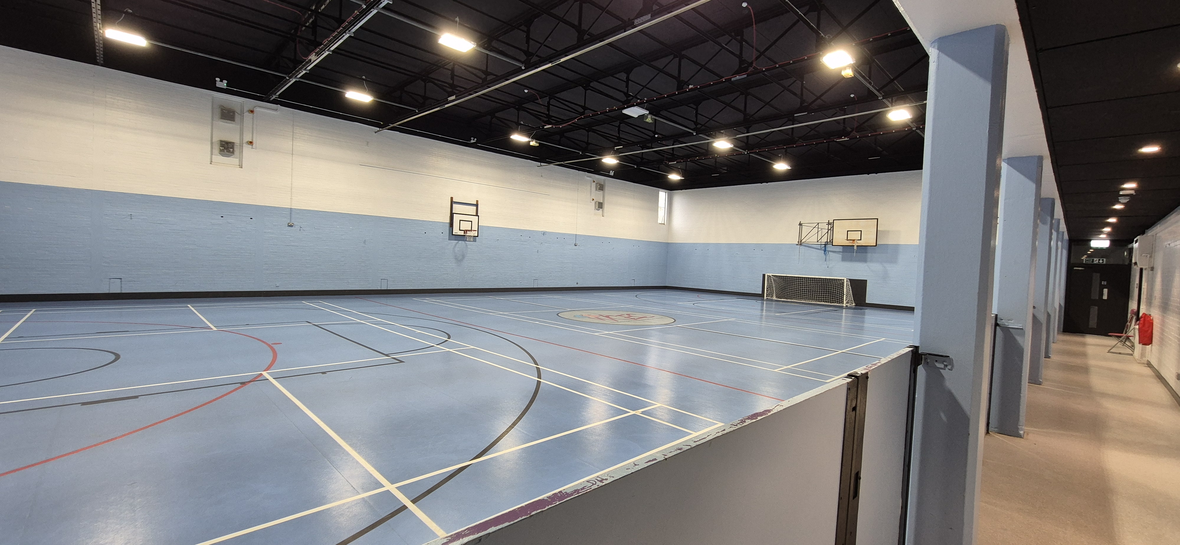 Sports Hall at Whitburn Community Centre — full-size indoor sports floor with basketball hoops and multi-sport court markings