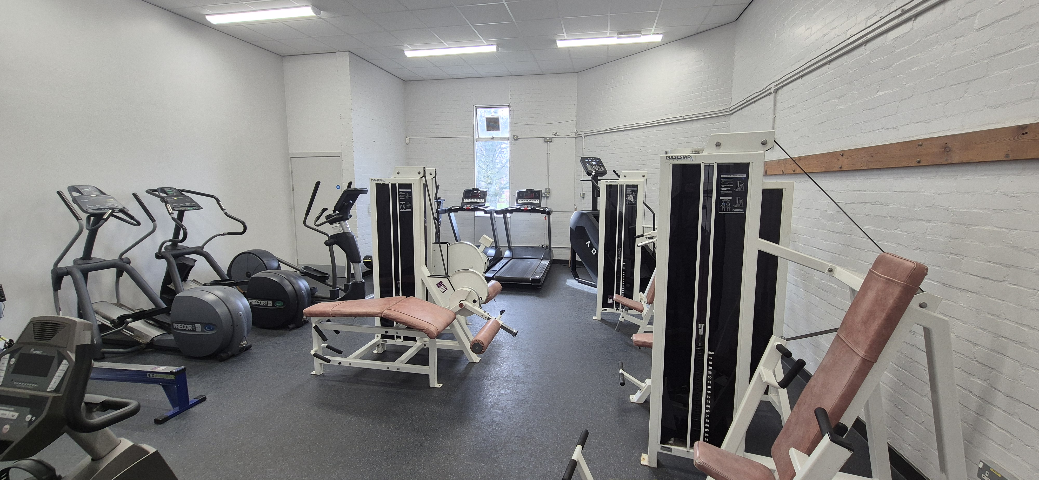 Gym at Whitburn Community Centre — cardio machines including treadmills, ellipticals, and weight resistance machines