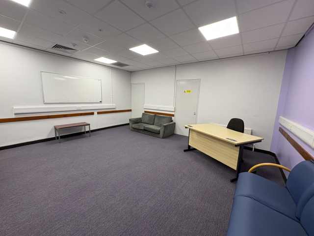 GP Room at Whitburn Community Centre — small private room with a desk, office chair and sofa seating, suitable for consultations and one-to-one appointments